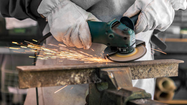 istock Craftsman grinding metal with disk grinder in workshop. Worker cleaning a steel 1430053640
