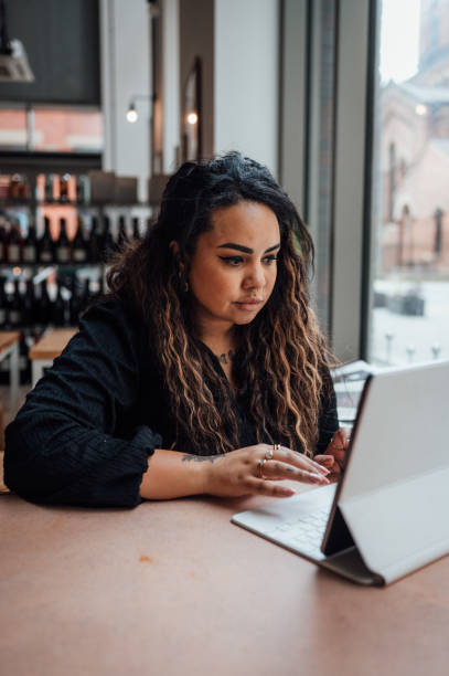 istock Woman working remotely from a cafe 1430054631