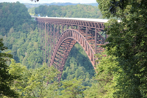 View through the trees of the New River Gorge Bridge in Fayetteville, West Virginia.