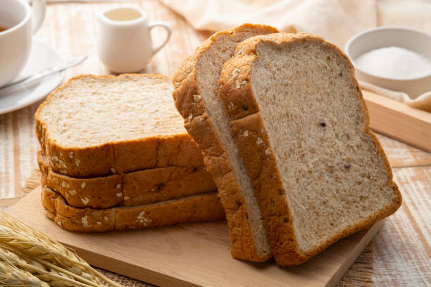 istock Sliced whole wheat bread on wooden cutting board 1430059879