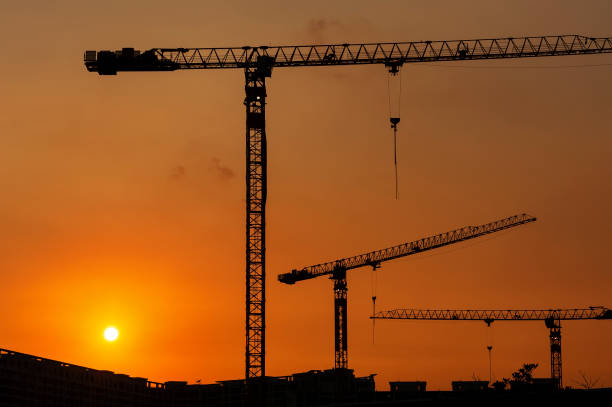 istock Silhouette of crane in construction site under sunset 1430061958