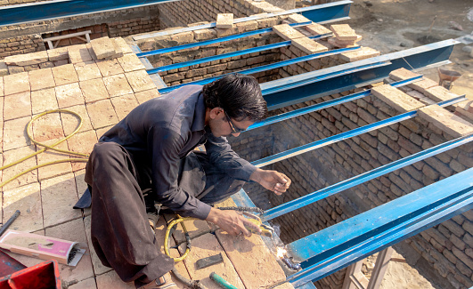 welder welding steel in rooftop on rooftop