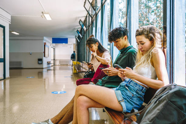 istock Multiracial students using smartphones in university hallway 1430070302