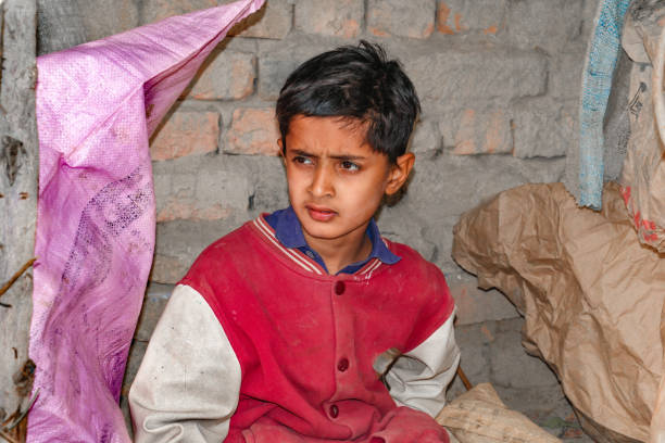 istock a homeless child is sitting in a slum 1430071505