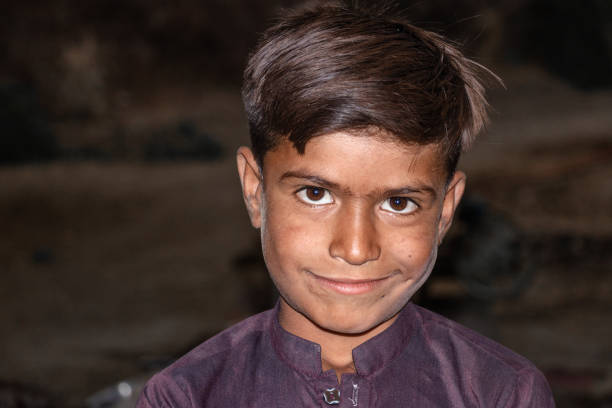 istock a young boy is smiling and darkness is in the background 1430073854