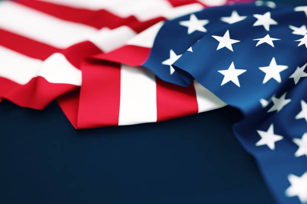 istock Rippled American Flag Sitting on Blue Background 1430075935