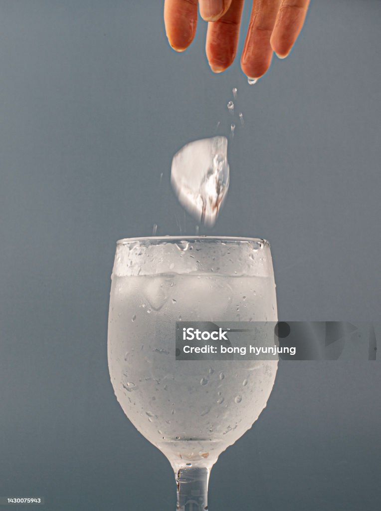 glass of water with ice isolated Blue Stock Photo