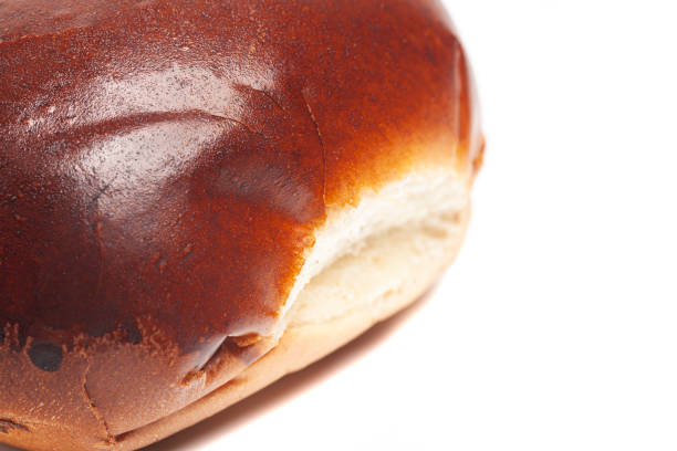 fresh baked wheat bun isolated on white
