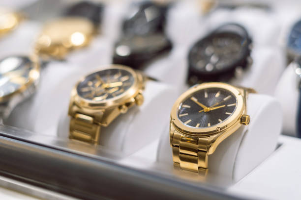 high end golden watches shop High-end gold-colored watches, exposed behind the window of a watch shop watch timepiece stock pictures, royalty-free photos & images