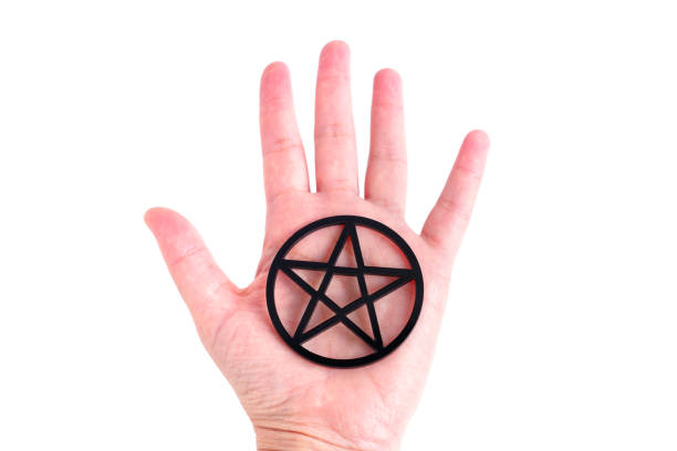 istock Large black pentagram resting on a hand palm 1430085163
