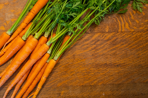 Fresh Carrots on a wooden tabletop