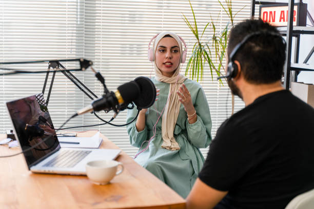 interview and discussion between a blogger and a muslim woman guest  on a live podcast show interview and discussion between a blogger and a muslim woman guest  on a live podcast show radio dj stock pictures, royalty-free photos & images