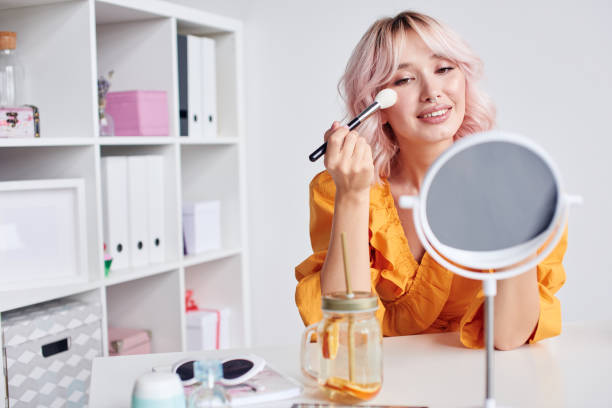 istock Pretty asian woman putting make up on 1430088521