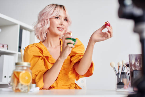 istock Beautiful woman speaking on camera about perfume 1430088537