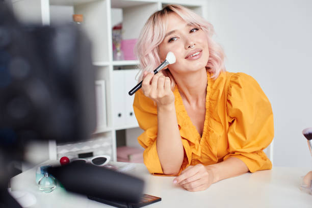 istock Pretty woman putting make up on cheeks 1430088567