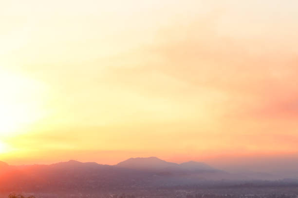 Smoke from a southern California wildfire fills the morning sky as the sun rises over the city of El Cajon, California in San Diego County.