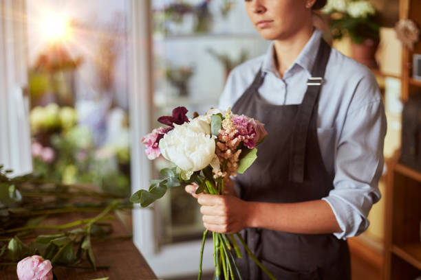 istock Florist arranging flowers for pink tender bouquet 1430091149