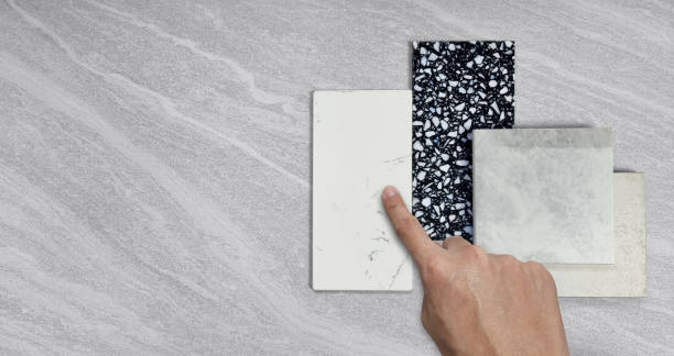 istock interior designer selecting material samples contains gloss and matt grey tiles, black and white terrazzo artificial stone, white marble quartz placed on grey travertine background. mood, tone board. 1430094100