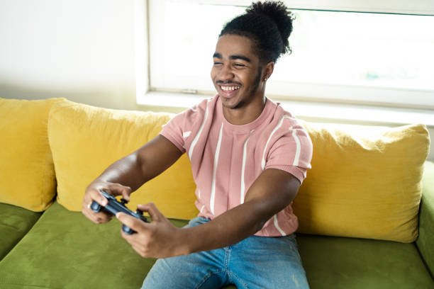 istock Young African American gaming and having fun 1430095686