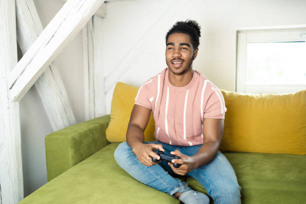 istock Young African American gaming and having fun at home 1430095695