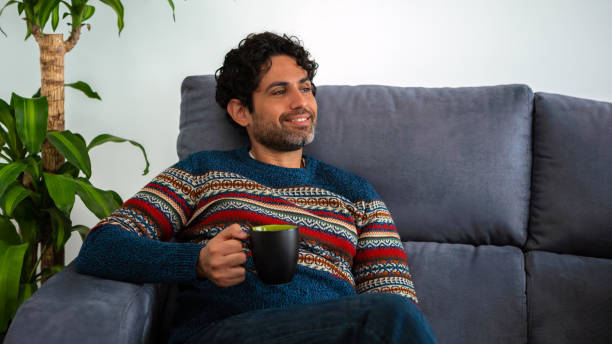 istock Handsome male model feeling happy and having coffee. Caucasian man drinking cafe 1430104755