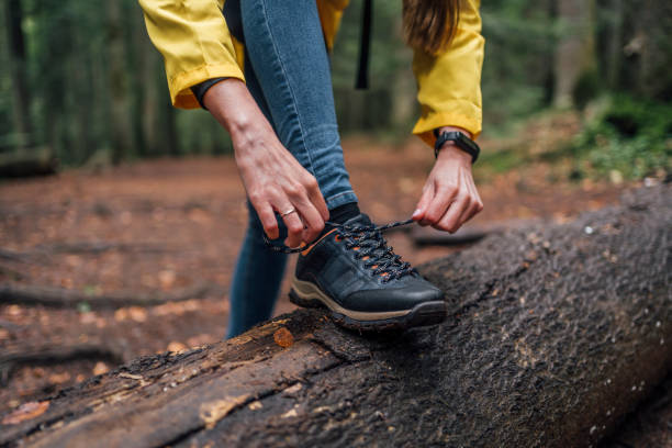 istock Woman tying a shoe in the forest 1430105294