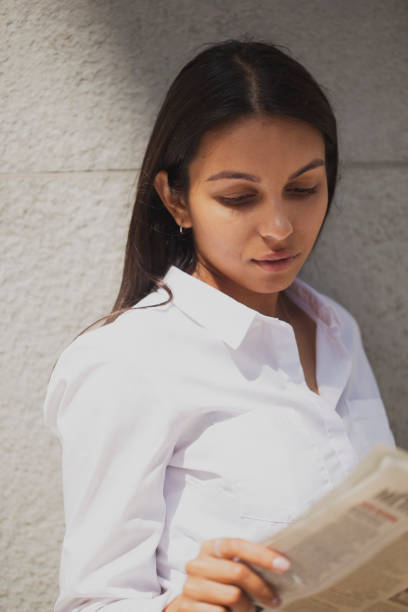 istock Business woman reading newspaper 1430108503