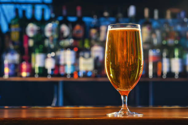 istock Fresh cold beer in glass on bar background 1430109734