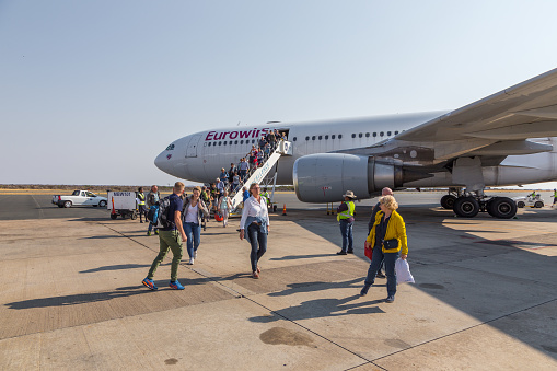 Windhoek, Namibia - 27 September 2018: Passengers disembarking from plane Airbus A320 Eurowings Airlines. Hosea Kutako International Airport.