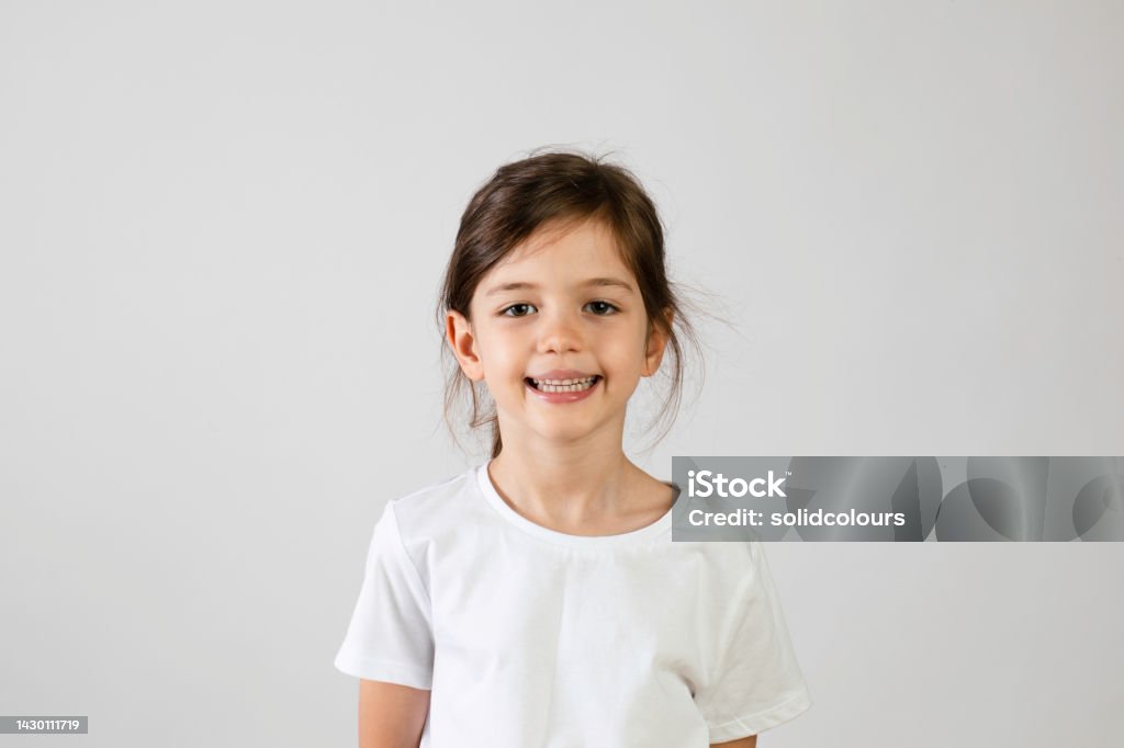 Six Year Old Girl Smiling Six year old girl looking at camera and smiling. Girls Stock Photo