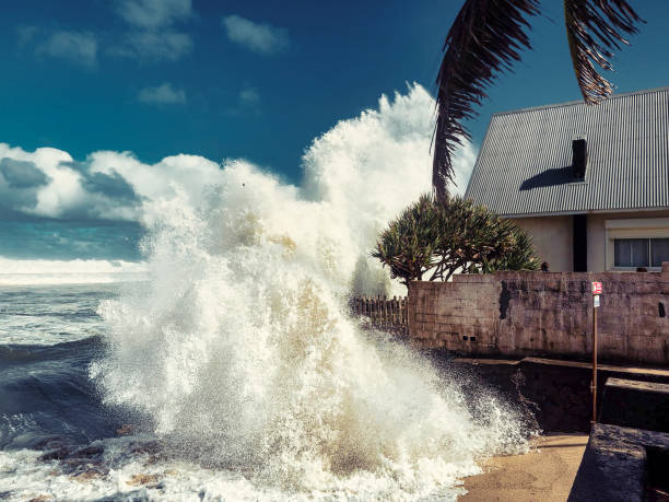 La Reunion, France - July 2, 2022. A view of a huge wave from the Indian Ocean crashing against a house built by the sea.