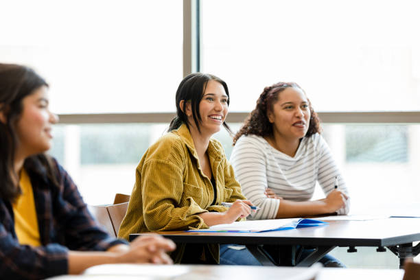 istock University students smile while listening to their peer 1430112958