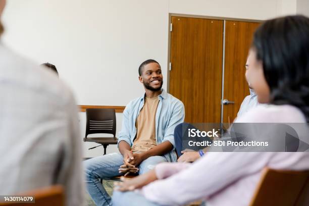 Young Adult Male Talks In The Group Stock Photo - Download Image Now - 16-17 Years, 20-24 Years, 25-29 Years