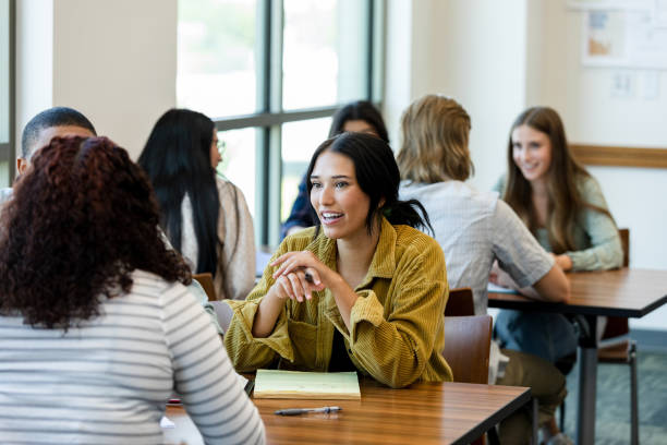 istock Young adults gather in small groups 1430114108