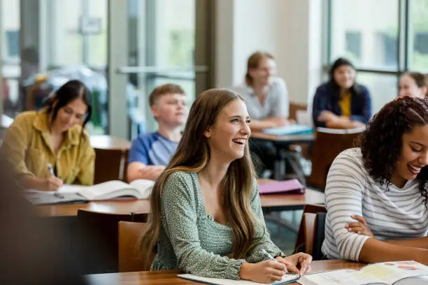 Photo of College students taking notes during class