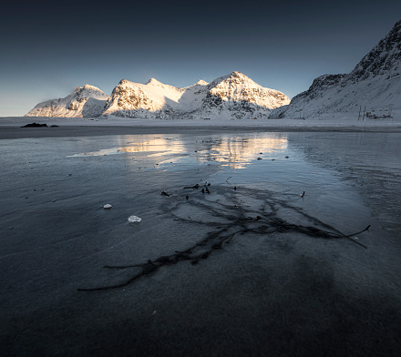 Frozen cracks at in the ice-covered sands at Skagsanden Beach
