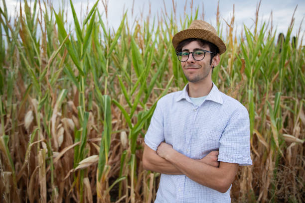 istock Smiling farmer with his hands crossed in front of his corn field, soon the corn will be ready for harvest 1430115820