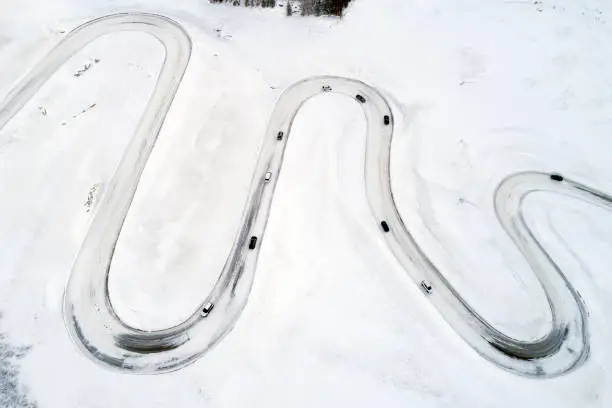 Aerial view of curvy winding road in Julier Pass, cars driving, Swiss Alps, Graubunden Canton (Canton of Grisons).