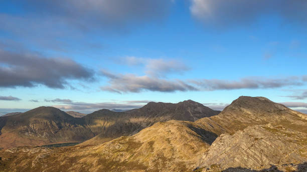 Panorama of sunset over the Twelve Bens mountain range from the Benlettery Panorama of sunset over the Twelve Bens mountain range in autumn in Connemara National Park in Galway county, Connacht, Ireland connemara national park stock pictures, royalty-free photos & images