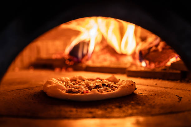 istock Pizza oven burning in flames getting ready to bake pizza 1430129541