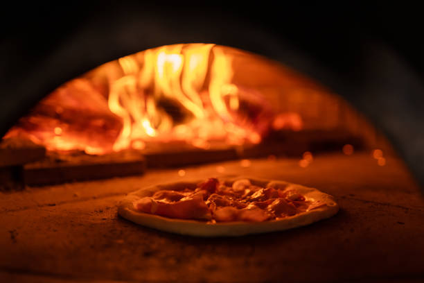 istock Pizza oven burning in flames getting ready to bake pizza 1430129572