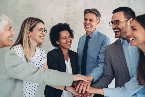 istock Multi ethnic group of business people standing in a circle with stacked hands 1430131675