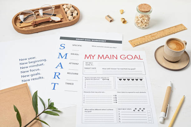 istock Desktop with goal setting template and office accessories. Organization, time managing, self-development concept. Top view, falt lay 1430131769