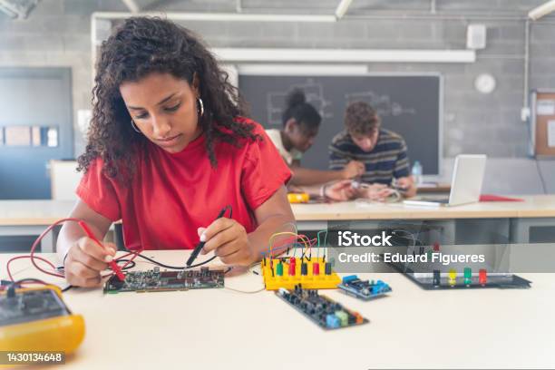 African American Female Teenager Student Working On Electronics Robotics In The Technology Course Stock Photo - Download Image Now
