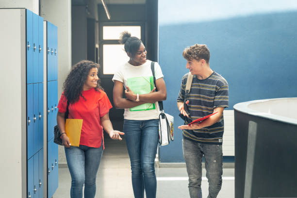 istock Multi ethnic group of confident and happy high school student friends going back to classes arriving to College 1430134803