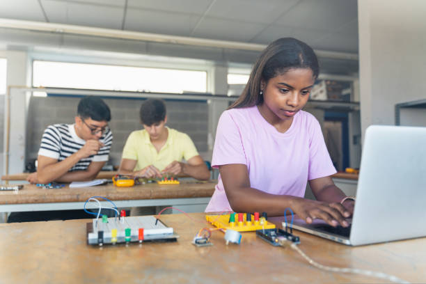 istock African American High School teenage Student programming electronics circuit board in the science technology workshop - Learning Digital Innovation in Education 1430135360