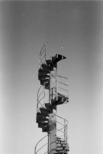 Spiral Stairway leading to nowhere. ending in the sky. art or architecture, I don't know.