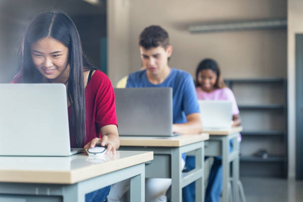 istock Diverse multi ethnic teenager college students studying with laptops at High School classroom 1430136425