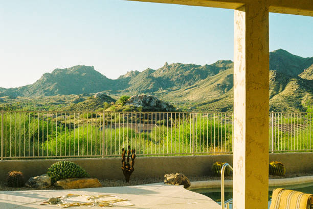 Scottsdale beautiful and scenic desert View from a Scottsdale backyard with a pool and mountains in the background. taken during golden hour on 35mm film. southwest usa architecture building exterior scottsdale stock pictures, royalty-free photos & images