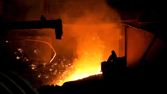 Iron and steel metallurgical plant, metallurgical production. Metal Melting process with many flying bright sparkles.